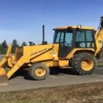 John Deere 210C John Deere backhoe loader excavator with front loader bucket and rear digging arm outdoors